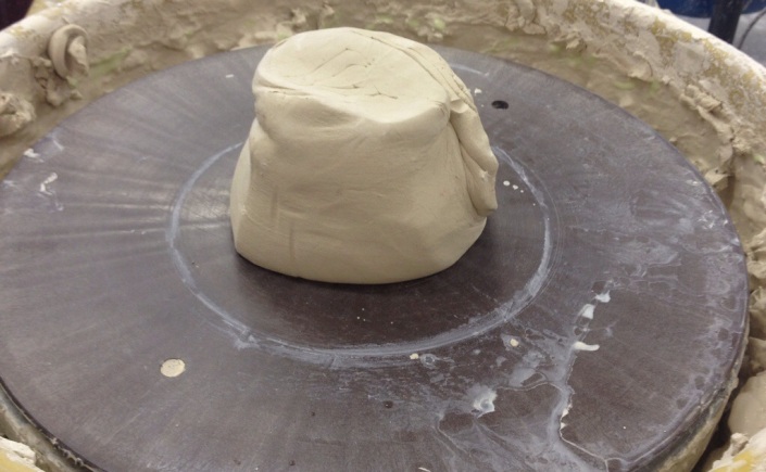 Centering clay on the potters wheel. 